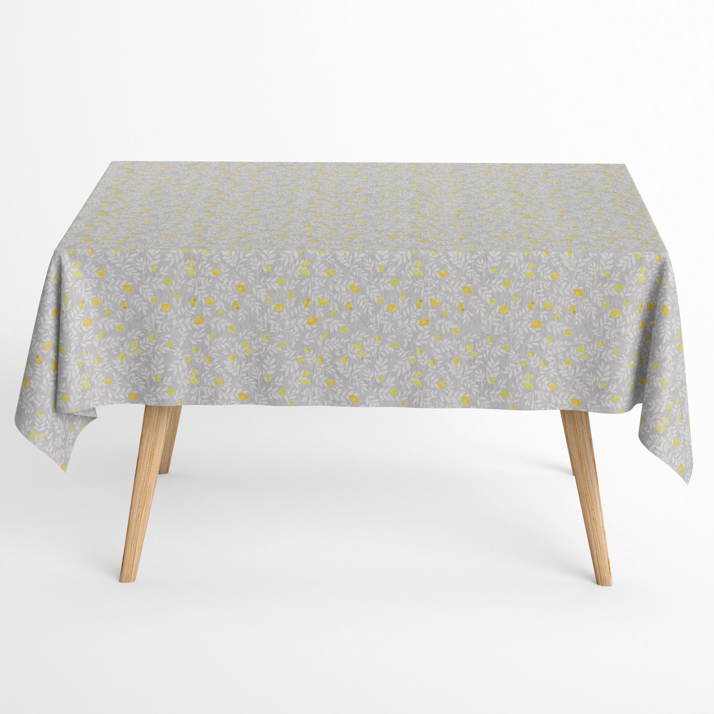 Die Jacquard Tischdecke aus beschichteter Baumwolle zeigt ein feines, dichtes Allover-Muster aus kleinen Zitronen und zarten Blättern in Gelb- und Grautönen.