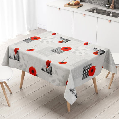 Wachstuch-Tischdecke mit modernem Mohnblumen-Motiv auf hellem Hintergrund. Das Design kombiniert leuchtend rote Mohnblüten mit geometrischen Mustern, filigranen Blattmotiven und dekorativen Schwarz-Weiß-Fotoelementen im Patchwork-Stil. Die wasserabweisende Tischdecke fällt gleichmäßig über die Kanten eines rechteckigen Tisches und ist vor weißem Hintergrund freigestellt dargestellt.