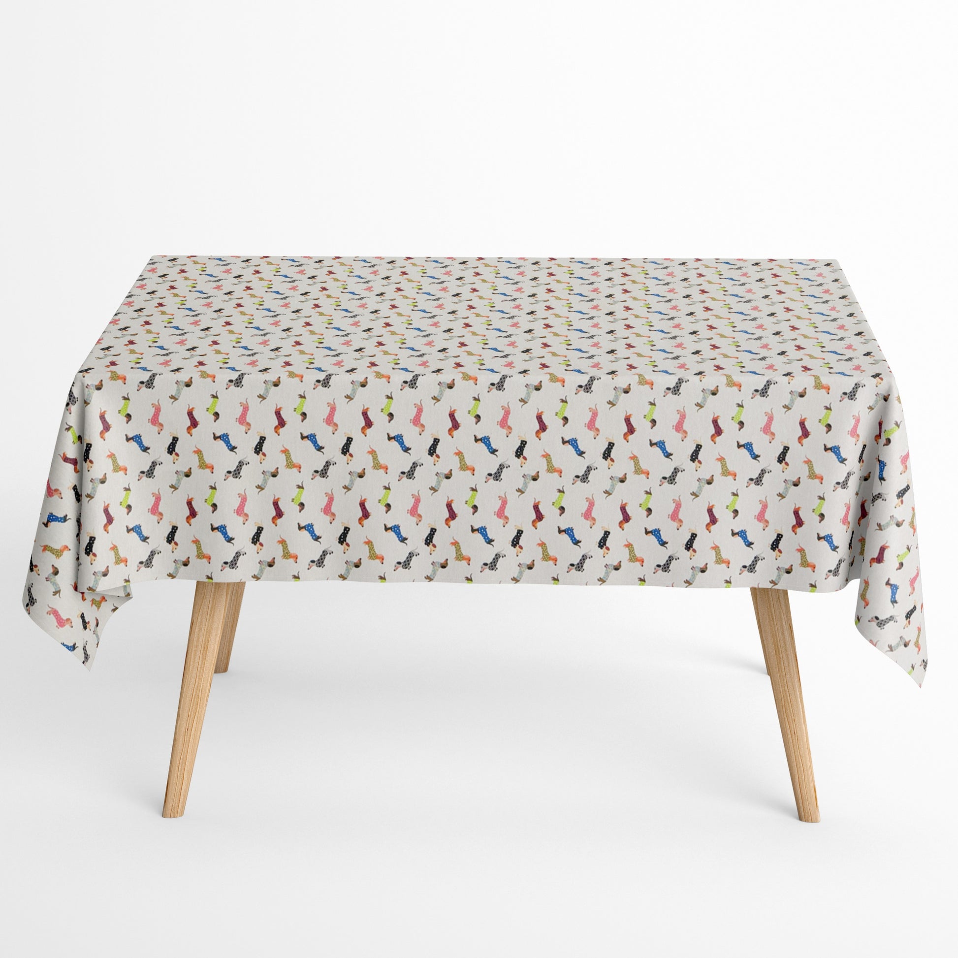 Jacquard Tischdecke aus beschichteter Baumwolle mit kleinem, buntem Dackel-Muster auf hellem Hintergrund, fleckenabweisend und pflegeleicht.
