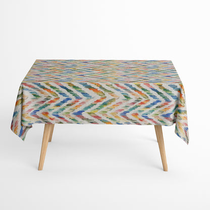 Beschichtete Jacquard-Baumwolltischdecke mit farbenfrohem Aquarellmuster aus dynamischen Pinselstrichen in Blau, Grün, Gelb, Orange und Rosé, fleckengeschützt und schmutzabweisend.