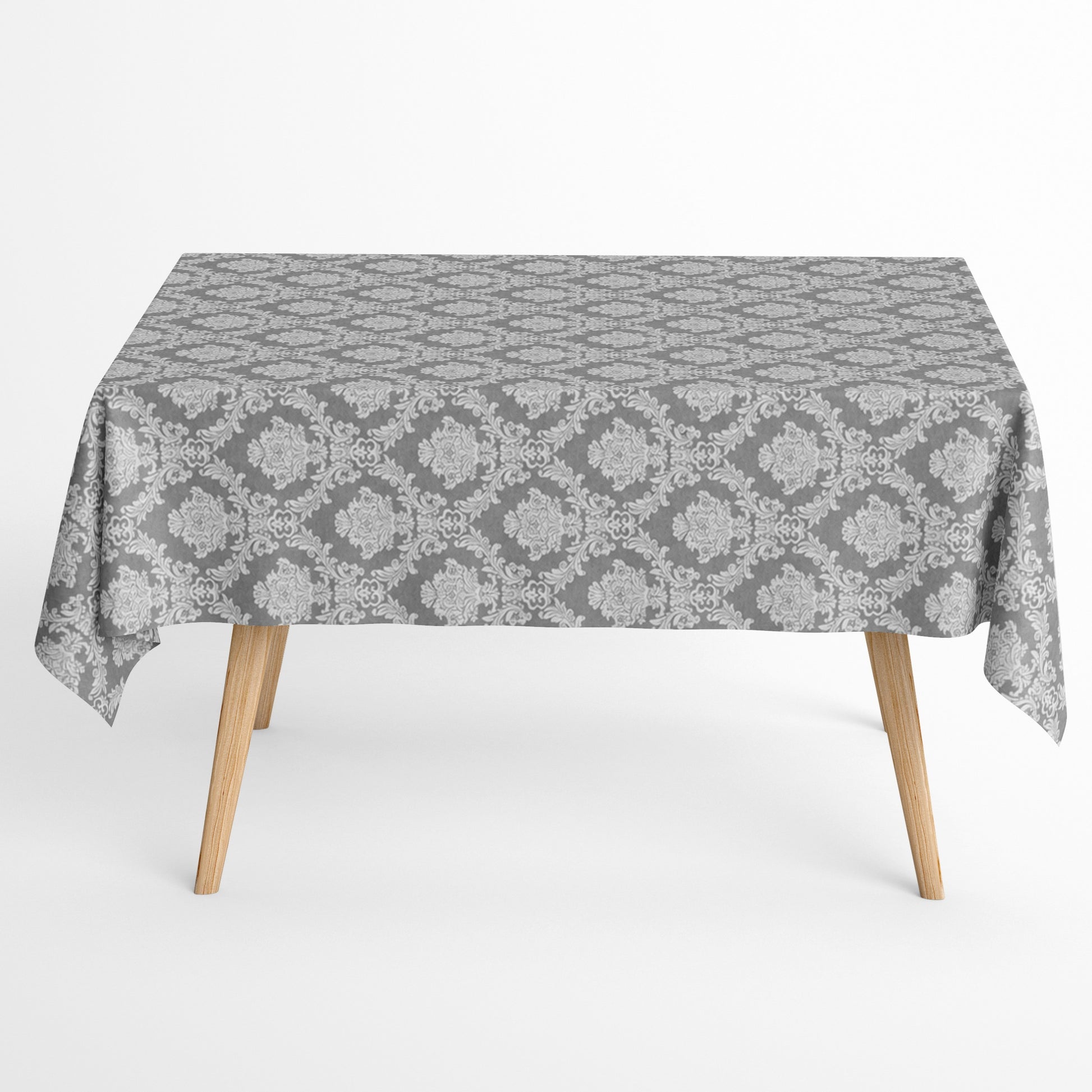 Detailaufnahme einer anthrazitfarbenen Jacquard-Tischdecke mit klassischem Ornamentmuster, beschichteter Baumwolle und Fleckenschutz.