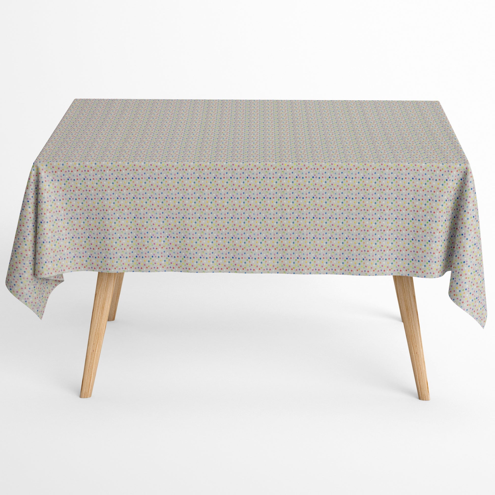 Jacquard-Tischdecke aus beschichteter Baumwolle mit hellem Grund und feinem, buntem Punktmuster in Blau, Rosa, Rot, Gelb, Grün, Orange und Violett.