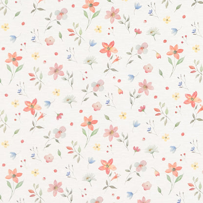Beschichtete Baumwoll-Tischdecke mit zartem Streublumenmuster auf hellem Hintergrund. Kleine Blüten, feine Zweige und dekorative Punkte in Rosa, Korall, Gelb, Blau und Grün verteilen sich gleichmäßig über die Oberfläche. Über eine Tischecke drapiert, mit sichtbaren hellen Holzbeinen.